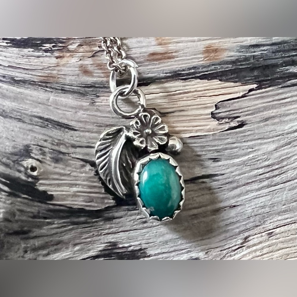 Stamped sterling silver and turquoise charm on 15-inch chain.